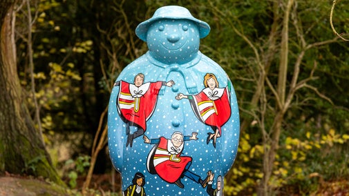 Pale blue and covered with white spots, this Snowman™ statue at Baddesley Clinton, Warwickshire, features several leaping lords